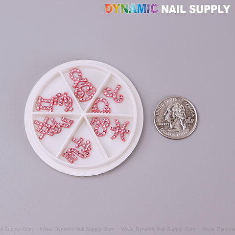 Set of Pink Zodiac Symbol Sign Nails Charm with Rhinestone shown with a round wheel and U.S. quarter for scale.