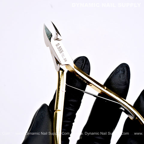 A gloved hand holds the D555 Professional Cuticle Nippers with high-tension spring and full jaw on a white background.
