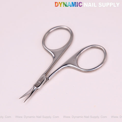 NT1216 Silver Professional Curved Tip Cuticle Scissors on light pink; Dynamic Nail Supply logo above.