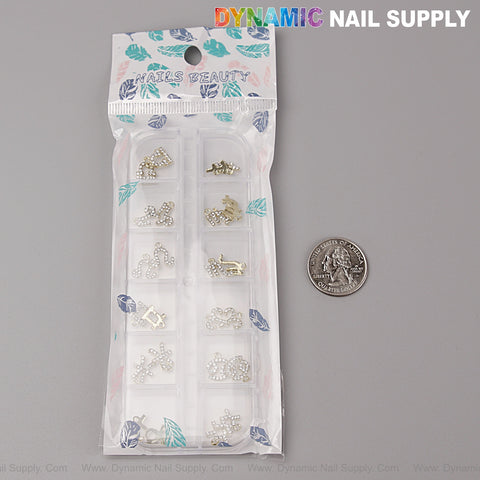 24 pcs Gold & Silver Rhinestone Zodiac Sign Charms for Nail Art, shown in case beside a U.S. quarter on gray surface.