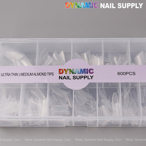A clear box holds 600 Ultra Thin Medium Almond Half Cover Nail Tips in 12 sizes from Dynamic Nail Supply.