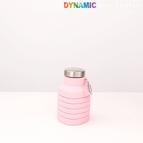 A Collapsible Silicone Lightweight Pink Bottle for travel/camping sits on white; Dynamic Nail Supply text above.