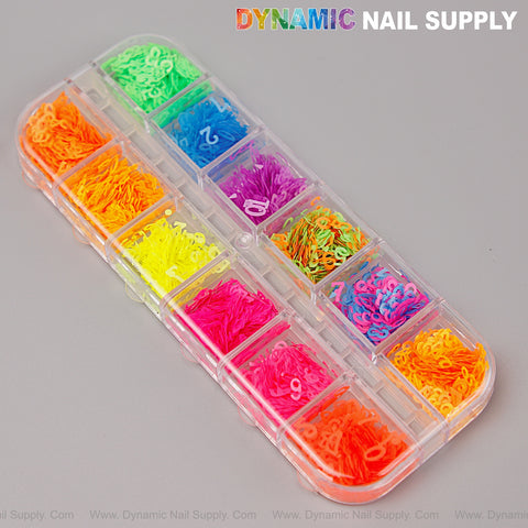 A clear box holds 12 compartments of Neon Nail Art Number Charms, sorted by color and labeled with white numbers.