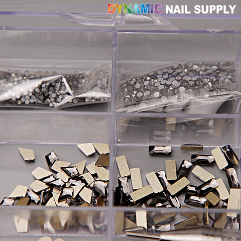 A 20-cell box holds 14 big and 6 round [Black Silver-back mixed Gold-back] rhinestones; DYNAMIC NAIL SUPPLY on top.