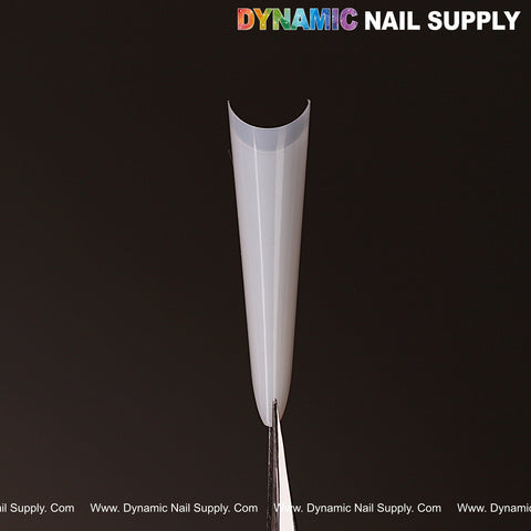 A natural white almond nail tip from the 504pcs Russia Almond Half Cover set is held upright by tweezers on black.