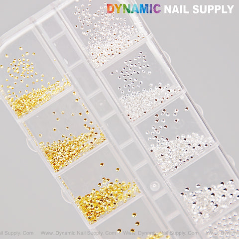 Close-up of Gold and Silver Hollow Semi-Sphere Beads Mixed Sizes Charms for Nail DIY Designs in a divided case.