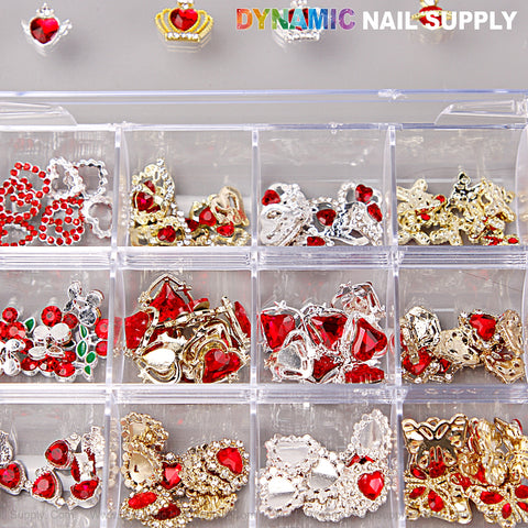 A box holds red, silver, and gold heart, cherry, crown & planet nail charms by DYNAMIC NAIL SUPPLY.