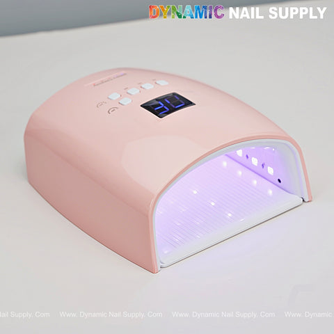 A [Stawberry Pink] Cordless 48W LED/UV Gel Nail Dryer glows on gray under the DYNAMIC NAIL SUPPLY text.