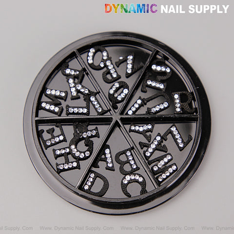 A round wheel holds 26pcs black with silver rhinestone A-Z letter nail charms for sparkling alphabet nail art.