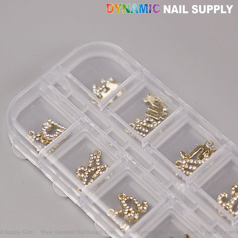 24 pcs Gold & Silver Rhinestone Zodiac Sign Nail Charms, “DYNAMIC NAIL SUPPLY” logo on gray surface.
