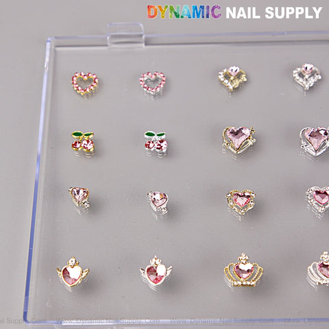 A clear tray holds Pink Silver Gold Heart Shape Cherry Crown Planet Nail Charms from DYNAMIC NAIL SUPPLY.