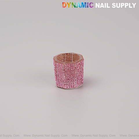A [Pink Rhinestone] Small Cup Dappen Dish sits beside a pink rhinestone nail drill bit sanding band on a light background.