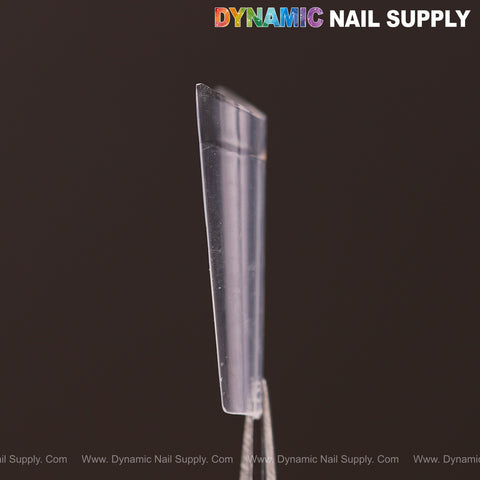 A clear, rectangular medium coffin nail tip held upright; Medium Coffin Nail Tips Half Cover - 600 pcs at the top.