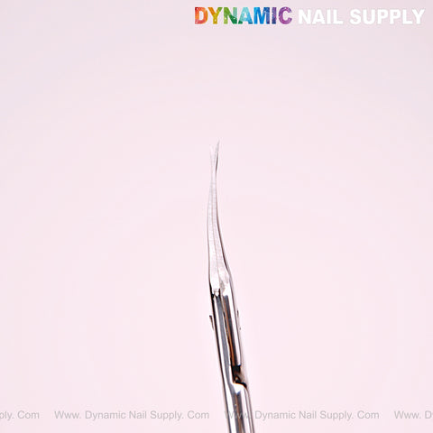 Close-up of NT1216 Silver Curved Tip Cuticle Scissors, stainless steel, with “DYNAMIC NAIL SUPPLY” in rainbow text above.