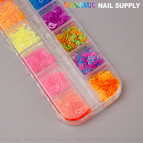 A clear organizer holds Colorful Neon Nail Sequins Number Charms in neon shades. DYNAMIC NAIL SUPPLY at top right.