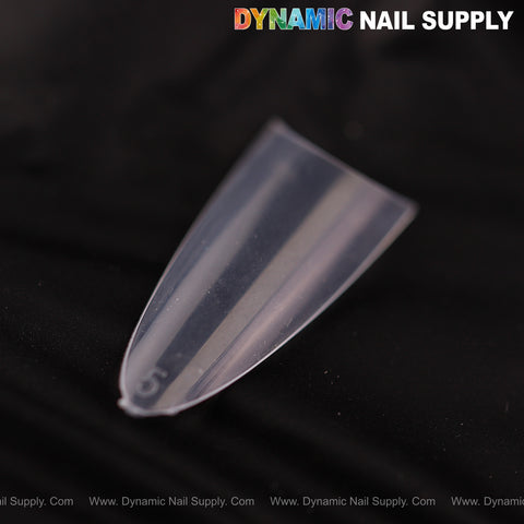 A clear Ultra Thin Medium Almond Extension Nail Tip rests on black; “DYNAMIC NAIL SUPPLY” appears above.