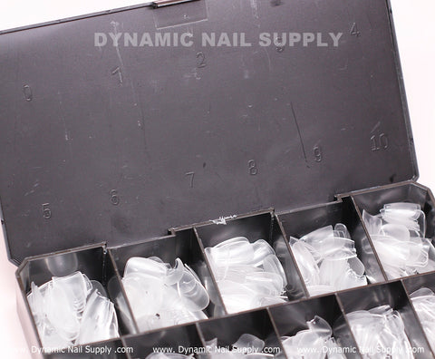 A sleek black plastic case with compartments numbered from 0 to 10, featuring Coffin XS full nail tips from Dynamic Nail Supply. The lid showcases the text "DYNAMIC NAIL SUPPLY," while the website www.DynamicNailSupply.com is elegantly repeated along the edge of this storage box.