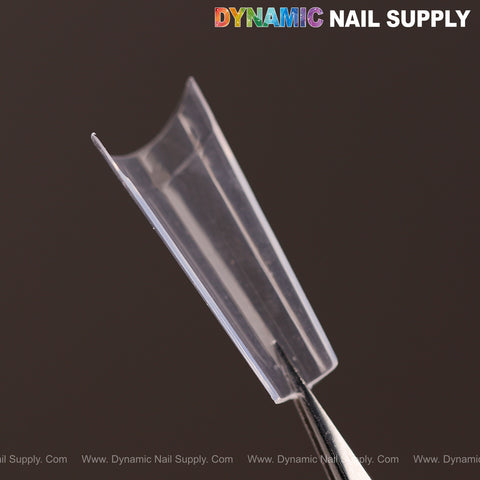 Medium Coffin Nail Tips Half Cover held by tweezers, DYNAMIC NAIL SUPPLY logo at top right.