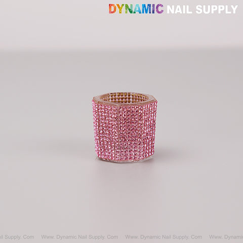 A Pink Rhinestone Small Cup Dappen Dish sits on a plain surface, with DYNAMIC NAIL SUPPLY at the top right.