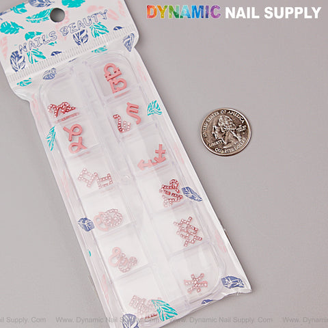 24 pcs Pink Rhinestone Zodiac Sign Charms—Twelve Constellation Nail Art Gems, shown next to a U.S. quarter.