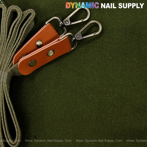 Two tan straps with metal clasps top a green Unisex Professional Cotton Canvas Apron with DYNAMIC NAIL SUPPLY at top right.