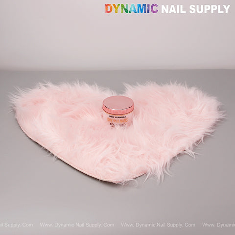 A Light Pink Faux Fur Heart Shape Mat is used as a display for nail art with DYNAMIC NAIL SUPPLY text above.