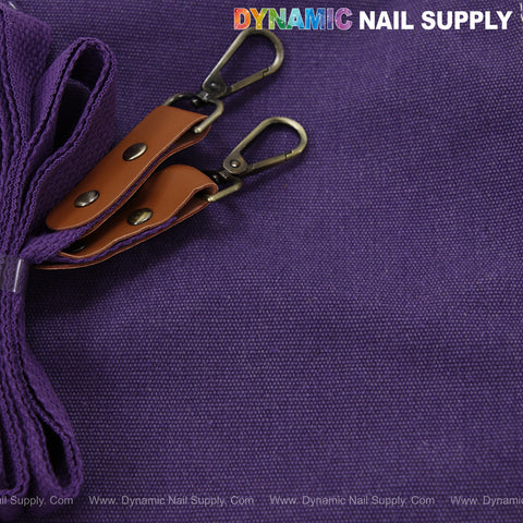 A purple cotton canvas Unisex Professional Apron with oversized pockets, cross back, and DYNAMIC NAIL SUPPLY logo.