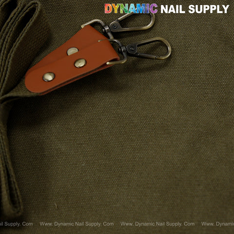 Close-up of olive Unisex Professional Apron with brown leather ends, metal clasps, and top right logo on cotton canvas.
