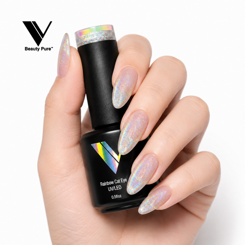 A hand with long, glitter nails holds a black bottle of V Beauty Pure Rainbow Cat Eye Gel Polish (HEMA-free).