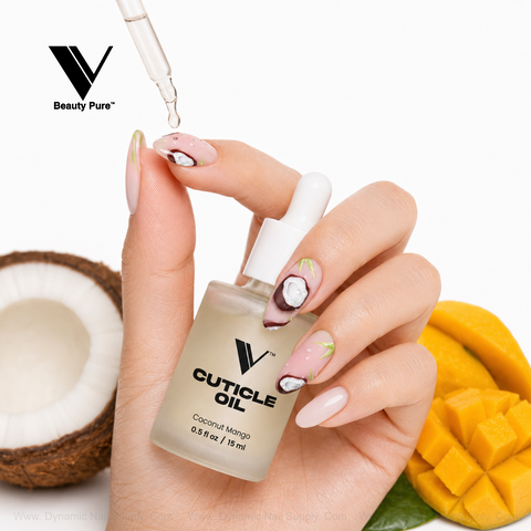 Hand with tropical nails applies V Beauty Pure Coconut Mango Cuticle Oil; mango slices accent this nourishing treatment.