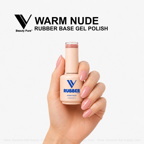 Hand with glossy nude-pink nails holds a Warm Nude - V Beauty Pure Rubber Base Gel Polish bottle against white.