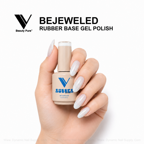 Hand holds V Beauty Pure Bejeweled Rubber Base Gel Polish, a dazzle-boosting nail strengthener, with speckled nails.