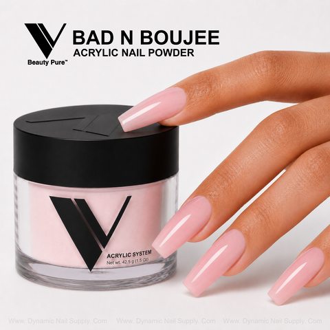 Long, glossy pink nails shine next to a V Beauty Pure - Bad N Boujee Acrylic Powder jar on a white surface.