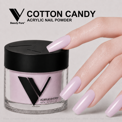 A hand with long, light pink nails holds V Beauty Pure - Cotton Candy Acrylic Powder, ideal for pro nail enhancements.