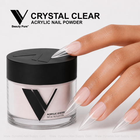 A hand with long, clear acrylics rests by a V Beauty Pure - Crystal Clear Acrylic Powder jar.