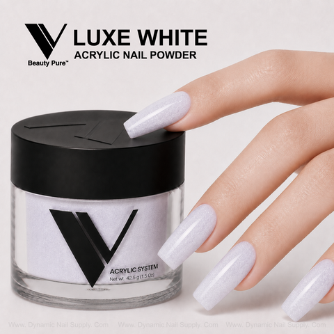 Hand with long, white acrylic nails next to V Beauty Pure - Luxe White Glittery Acrylic Powder, a nail supply essential.