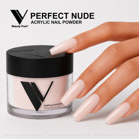 A hand with glossy nude nails holds a V Beauty Pure Perfect Nude Acrylic Powder jar.