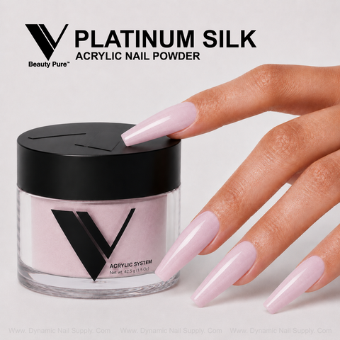 A hand with long pink acrylics touches a jar of Platinum Silk - V Beauty Pure Acrylic Powder on a light background.