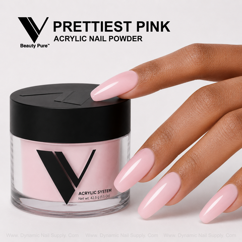 A hand with long pink acrylics holds a jar of V Beauty Pure - Prettiest Pink Acrylic Powder against a light background.