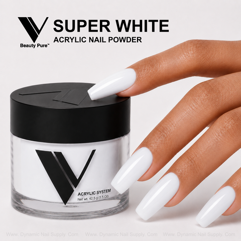 A hand with long French acrylics holds a V Beauty Pure - Super White Acrylic Powder jar against a light background.