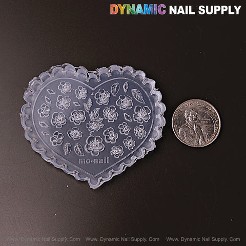 Mixed Size 3D Flowers with Leaves silicone nail art mold for embossed charms is shown beside a U.S. quarter on a dark surface.