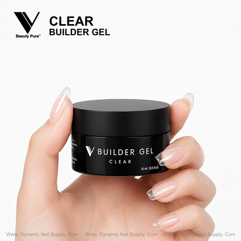 A manicured hand holds V Beauty Pure Clear Builder Gel by Dynamic Nail Supply, offering a flawless crystal-clear finish.