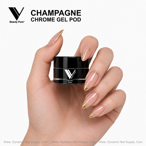 Hand with gold-tipped nude nails holds Champagne Chrome Gel Pod by Dynamic Nail Supply, ideal for metallic nail art.