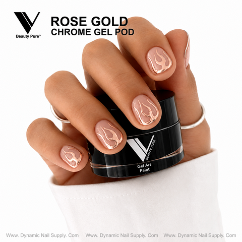 A hand with rose gold flame nail art holds a Rose Gold V Beauty Pure Chrome Gel Pod by Dynamic Nail Supply.