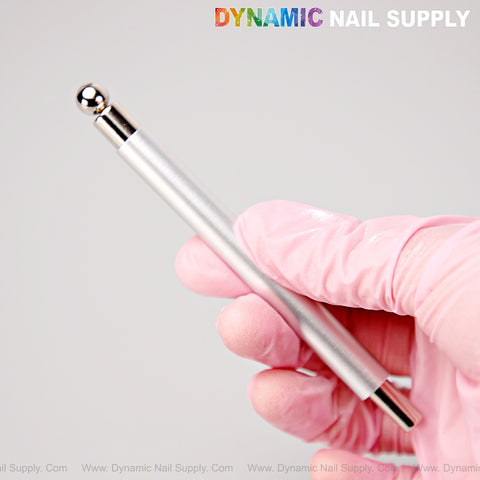 A gloved hand holds the [Silver] Dual Head Strong Cat Eye Magnet with Ball for gel nail art; logo is visible.