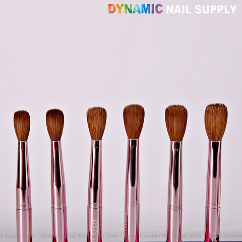 Six Dynamic Metallic Pink 100% Pure Kolinsky Hair Brushes are lined up under the logo on a white background.