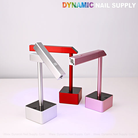 Three modern 2-in-1 Mini UV/LED Flash Cure Lamps in silver, red, and pink sit on square white bases.