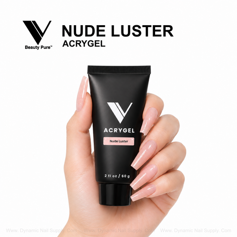 A hand with long nude nails displays a Nude Luster - V Beauty Pure AcryGel tube for salon-quality nails.