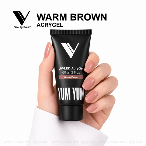 Manicured hand holds Warm Brown - V Beauty Pure AcryGel tube for pro nails, set against a white background.