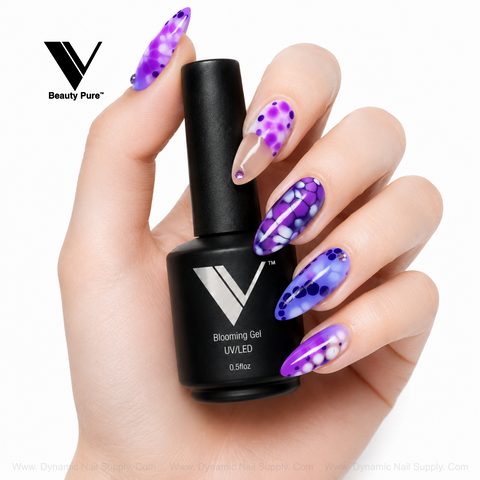 A hand with long, purple-blue dotted nails holds V Beauty Pure - Blooming Gel, perfect for marble nail designs.